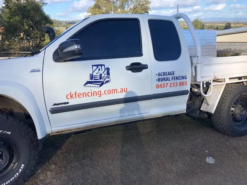 A white truck is parked on the side of the road.