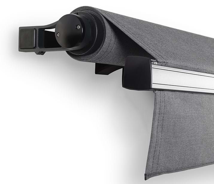 Gray retractable awning, partially extended, mounted on a white wall. Gray retractable awning, partially extended, mounted on a white wall.