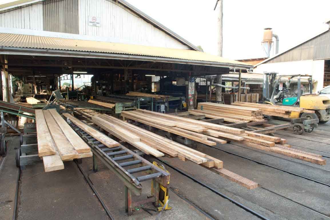A Warehouse Filled With Lots Of Wooden Boards And A Forklift – Beaudesert, QLD - Enrights Sawmill