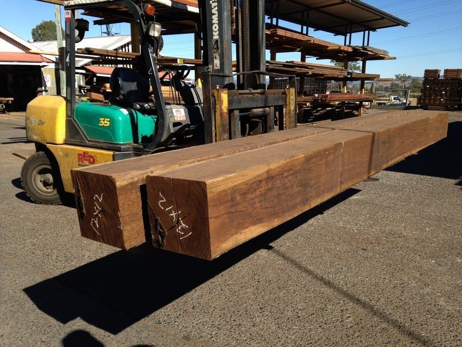 A Yellow And Green Forklift Is Carrying A Large Wooden Beam – Beaudesert, QLD - Enrights Sawmill