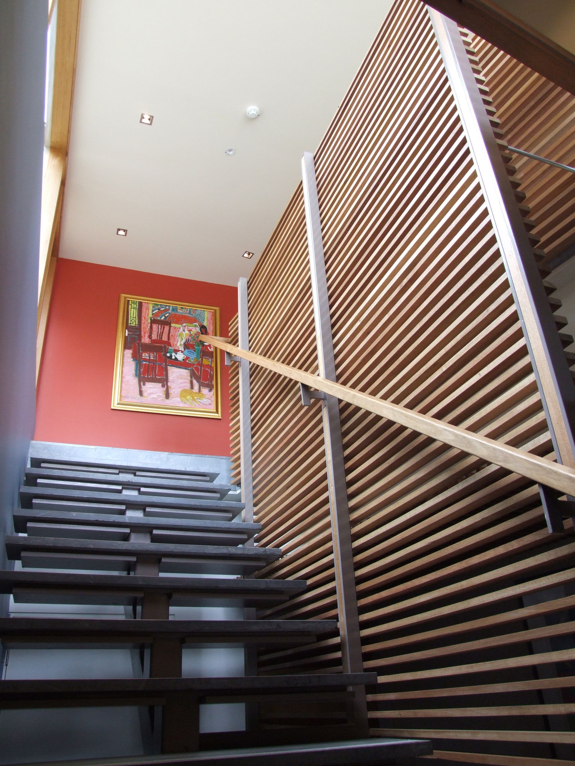 A Staircase With A Wooden Railing And A Painting On The Wall – Cambridge, TAS - Bennett Construction (TAS)