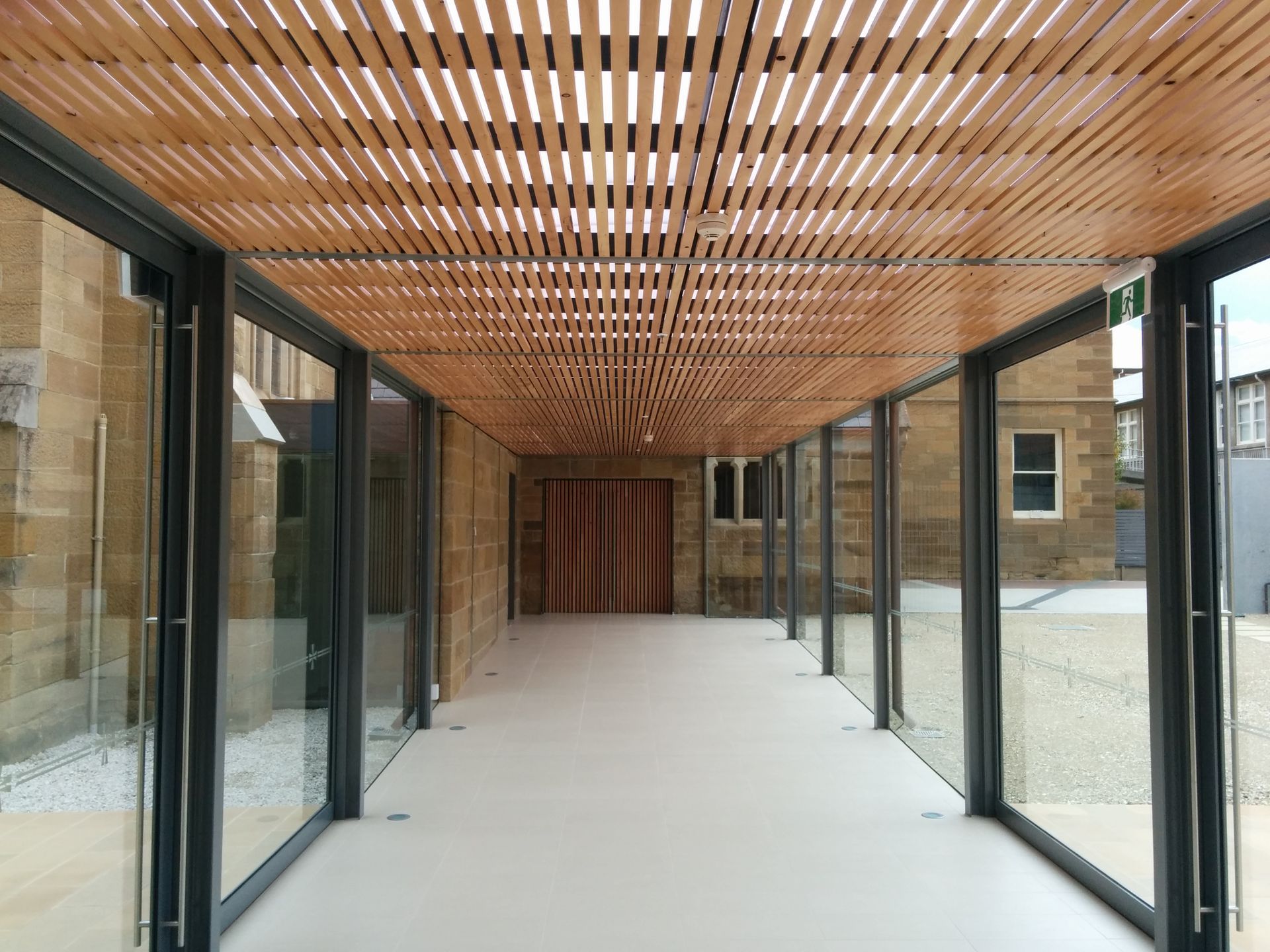 A Long Hallway With Lots Of Windows And A Wooden Ceiling – Cambridge, TAS - Bennett Construction (TAS)
