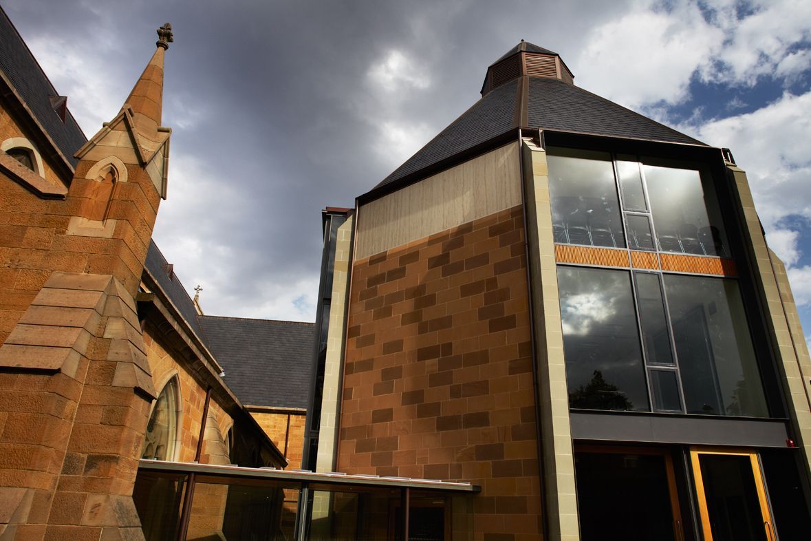 A Church With A Steeple And A Modern Building In Front Of It – Cambridge, TAS - Bennett Construction (TAS)
