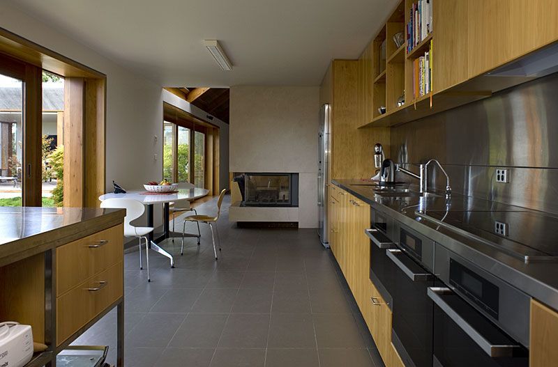 A Kitchen With Stainless Steel Appliances And Wooden Cabinets – Cambridge, TAS - Bennett Construction (TAS)
