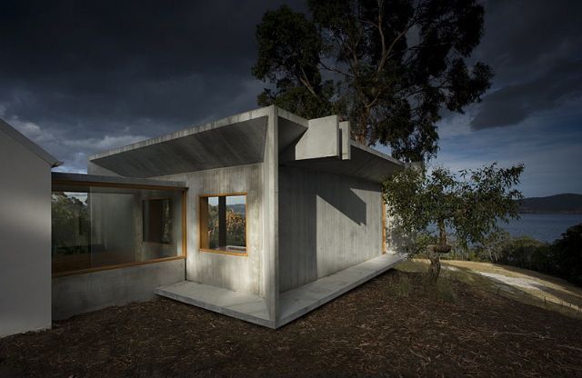 A Small White House Is Sitting On Top Of A Hill Next To A Tree – Cambridge, TAS - Bennett Construction (TAS)