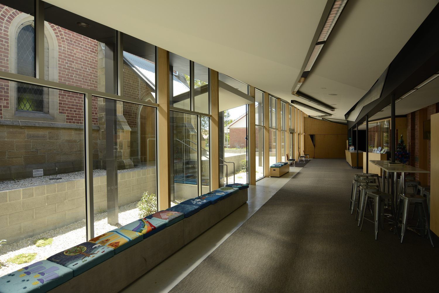 A Long Hallway With A Lot Of Windows And Tables – Cambridge, TAS - Bennett Construction (TAS)