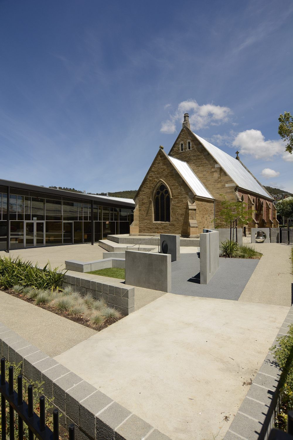 A Church With A White Roof Is Surrounded By A Fence And A Walkway – Cambridge, TAS - Bennett Construction (TAS)