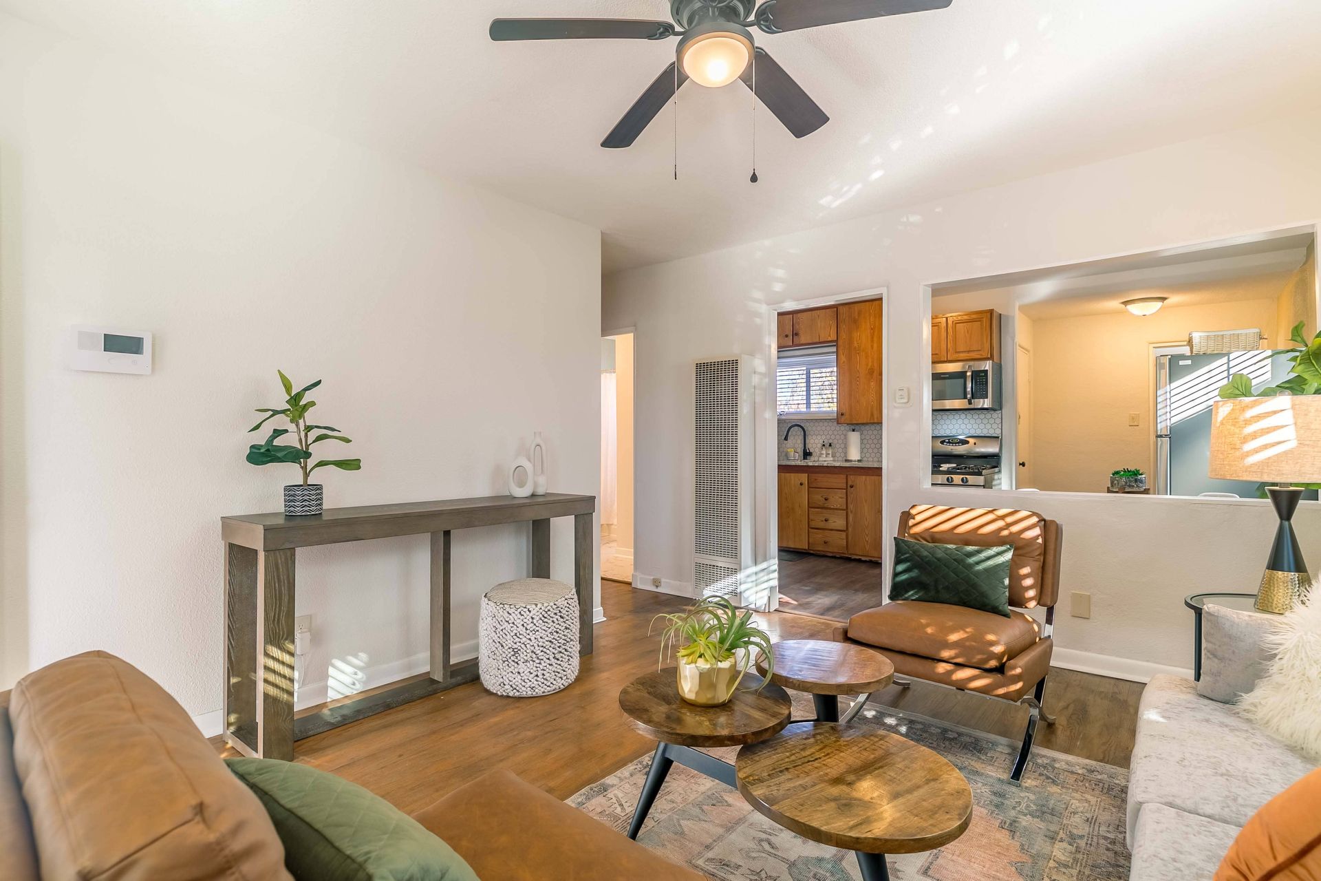 A living room filled with furniture and a ceiling fan.