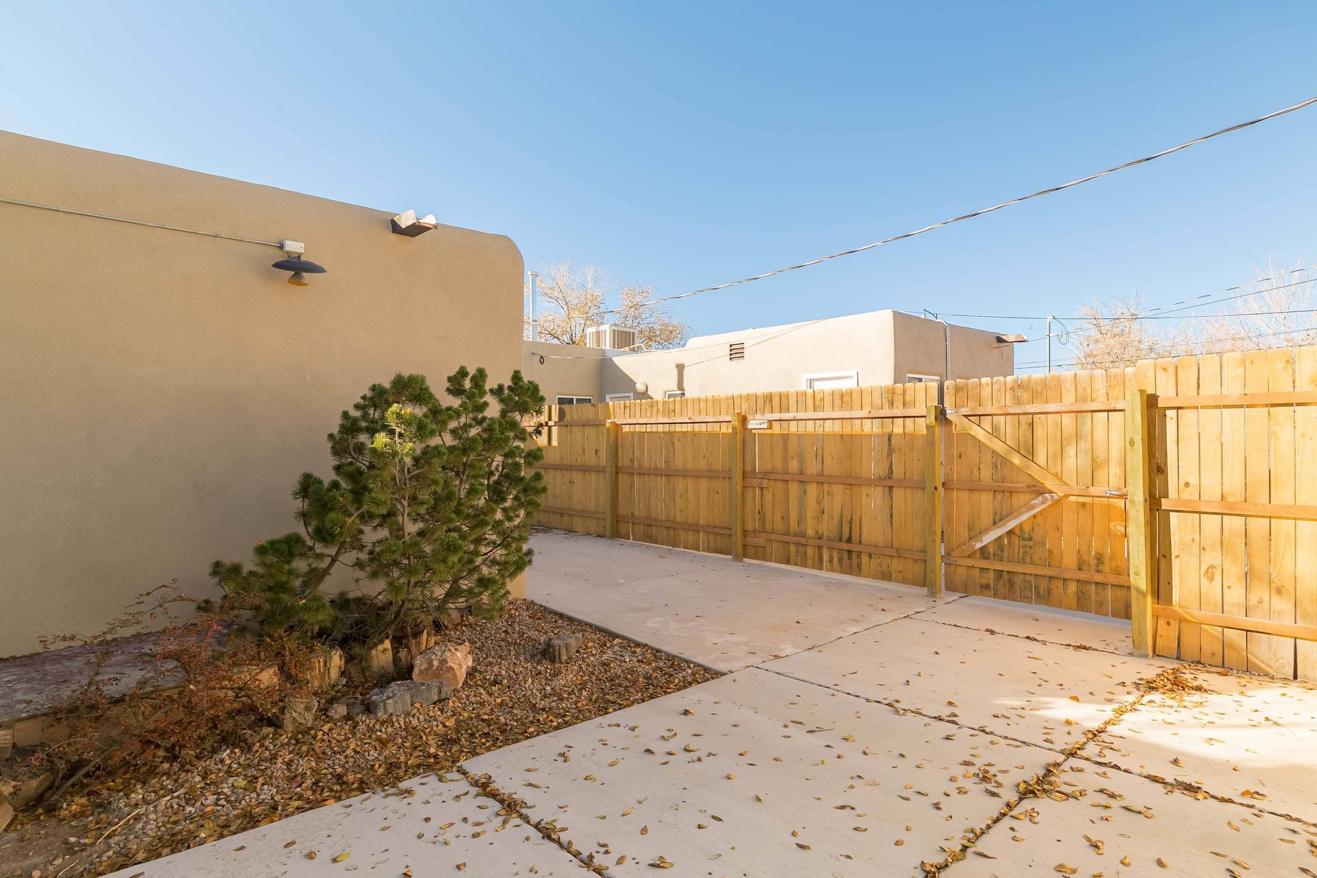 There is a wooden fence in the backyard of a house.