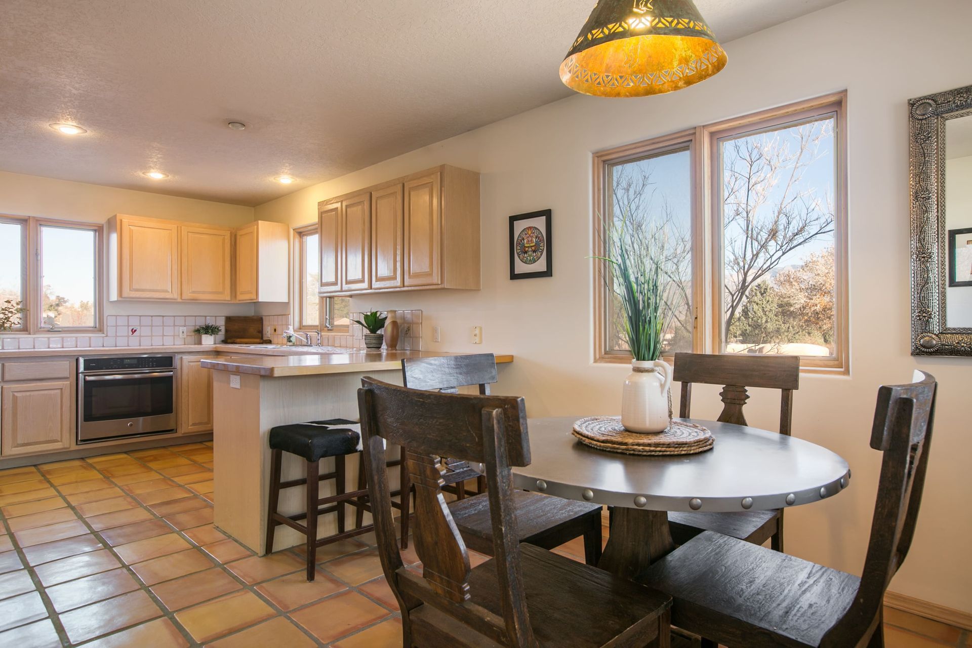 A kitchen with a table and chairs in it