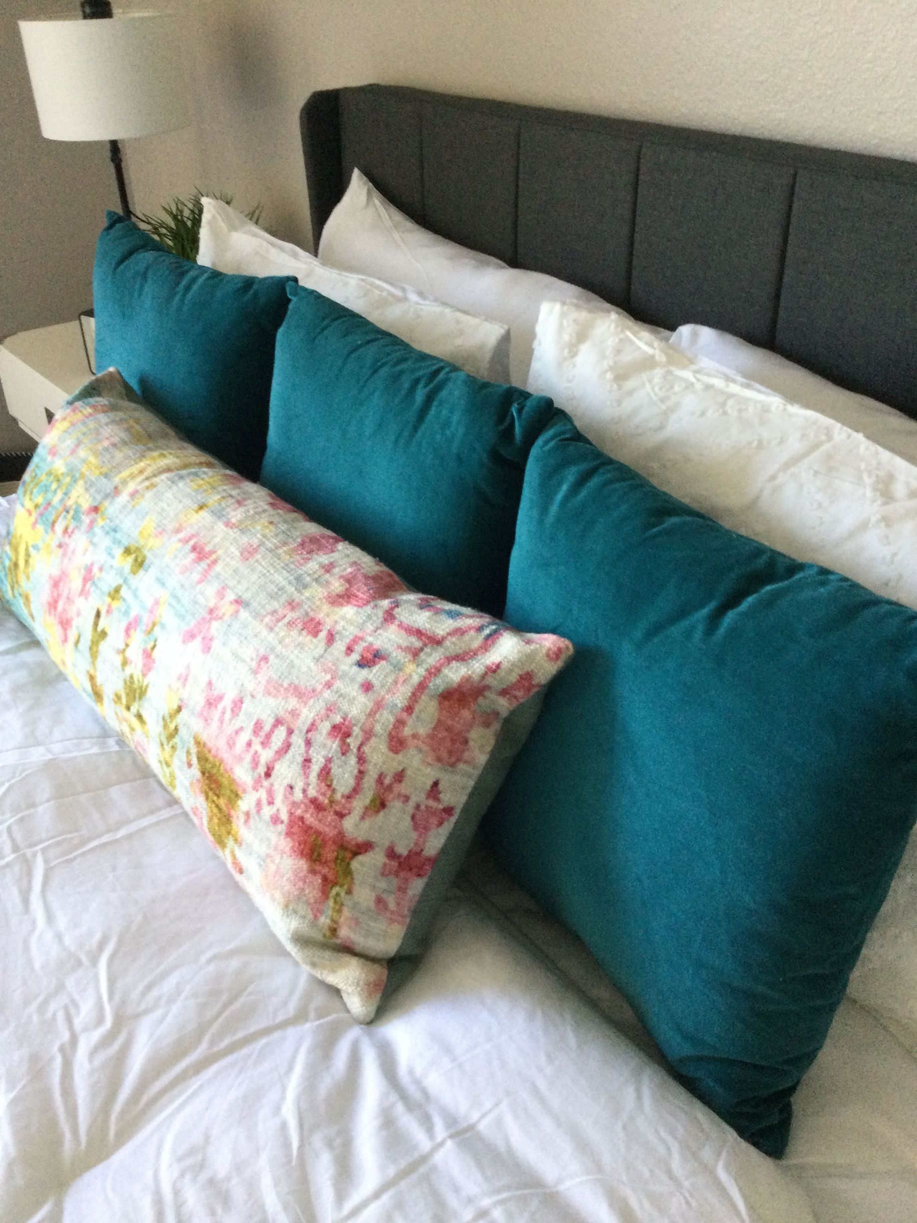 A bed with a lot of pillows on it