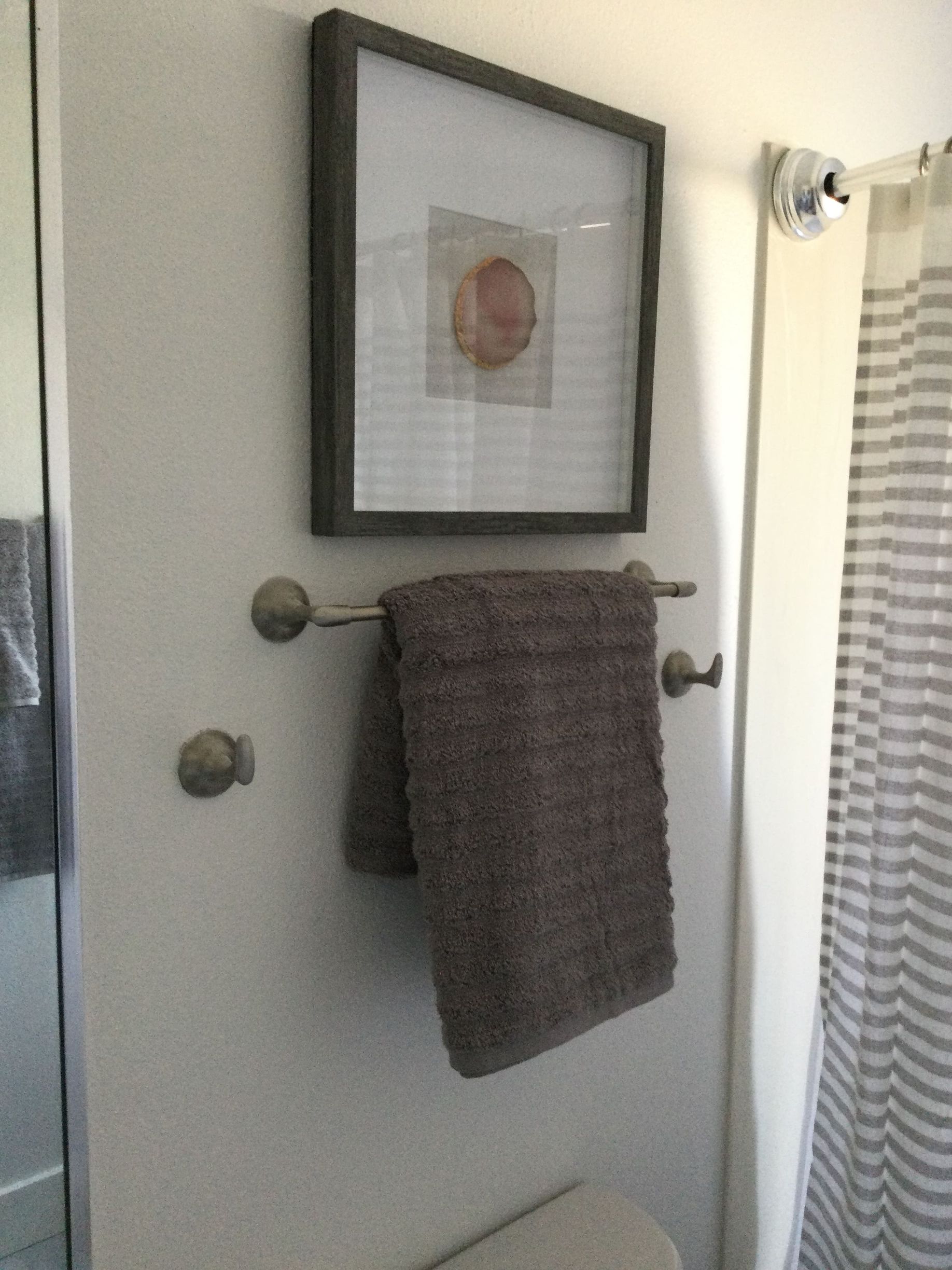 A towel is hanging on a towel rack in a bathroom.