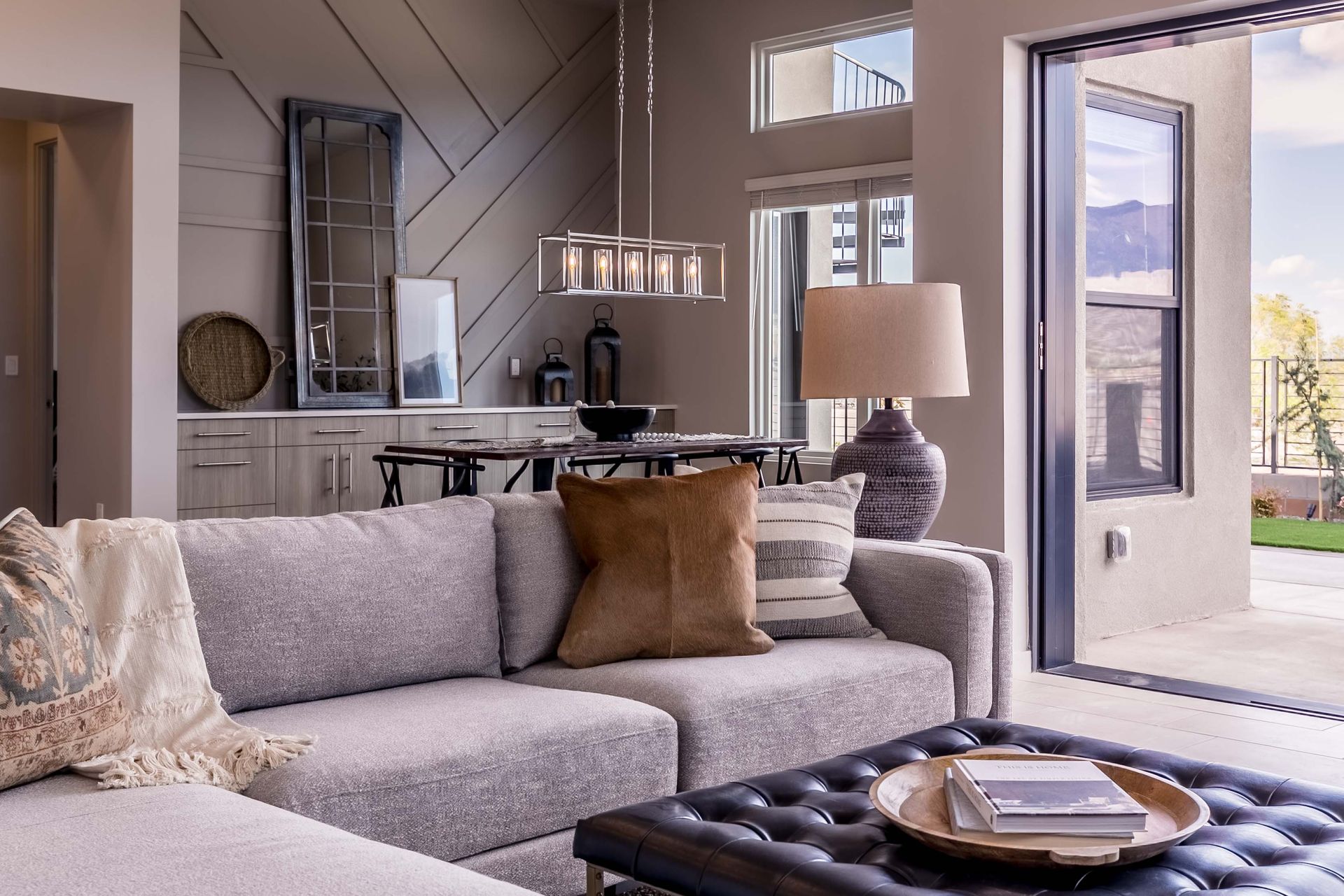 A living room with a couch , coffee table , and sliding glass doors.