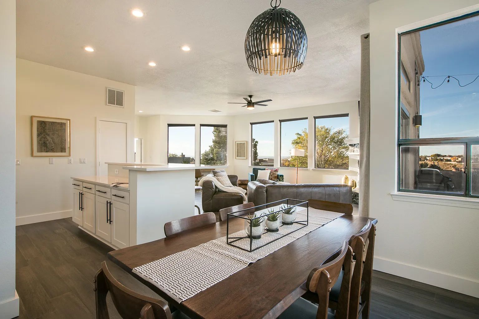 There is a dining table and chairs in the middle of the room.