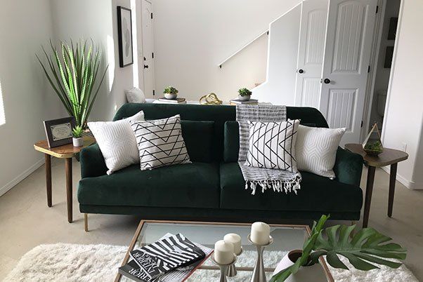 A living room with a green couch and a coffee table.