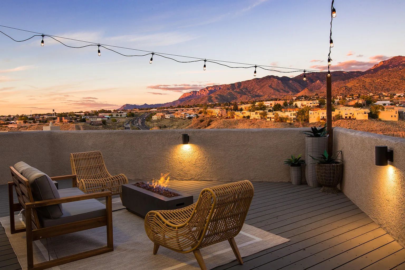 There is a fire pit on the deck with a view of the mountains.