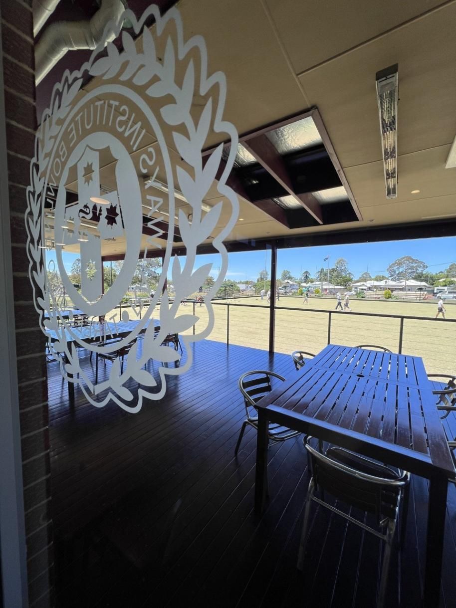A Room With A Table And Chairs And A Logo On The Window — Taree Railway Bowling Club Ltd In Taree, NSW