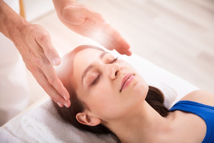 Reiki Healing Treatment On Woman