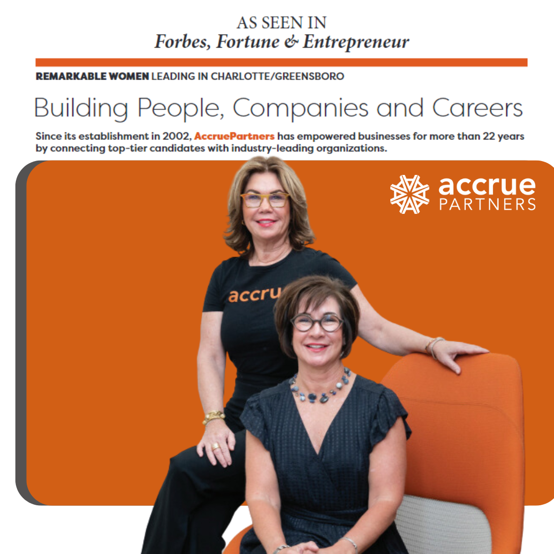 Two women are sitting next to each other on a poster for AccruePartners in Forbes