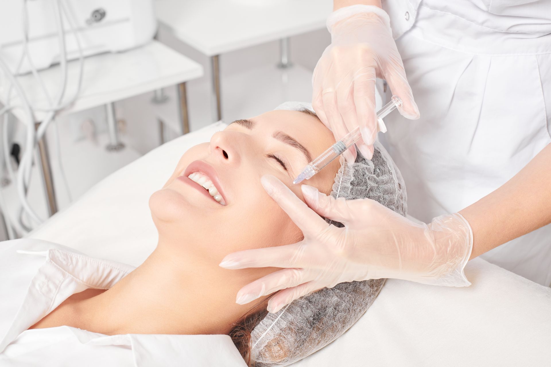 A woman is getting an injection in her face in a beauty salon.