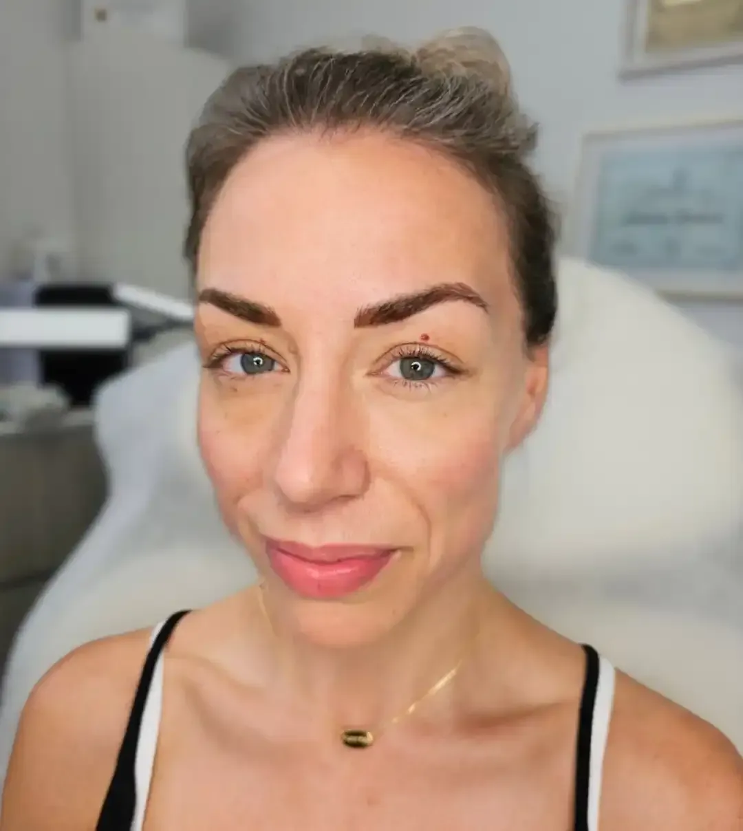A close up of a woman 's face with a necklace around her neck