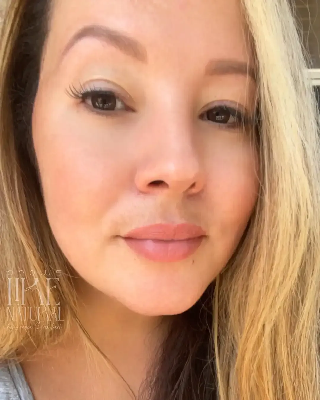 A close up of a woman 's face with long blonde hair.