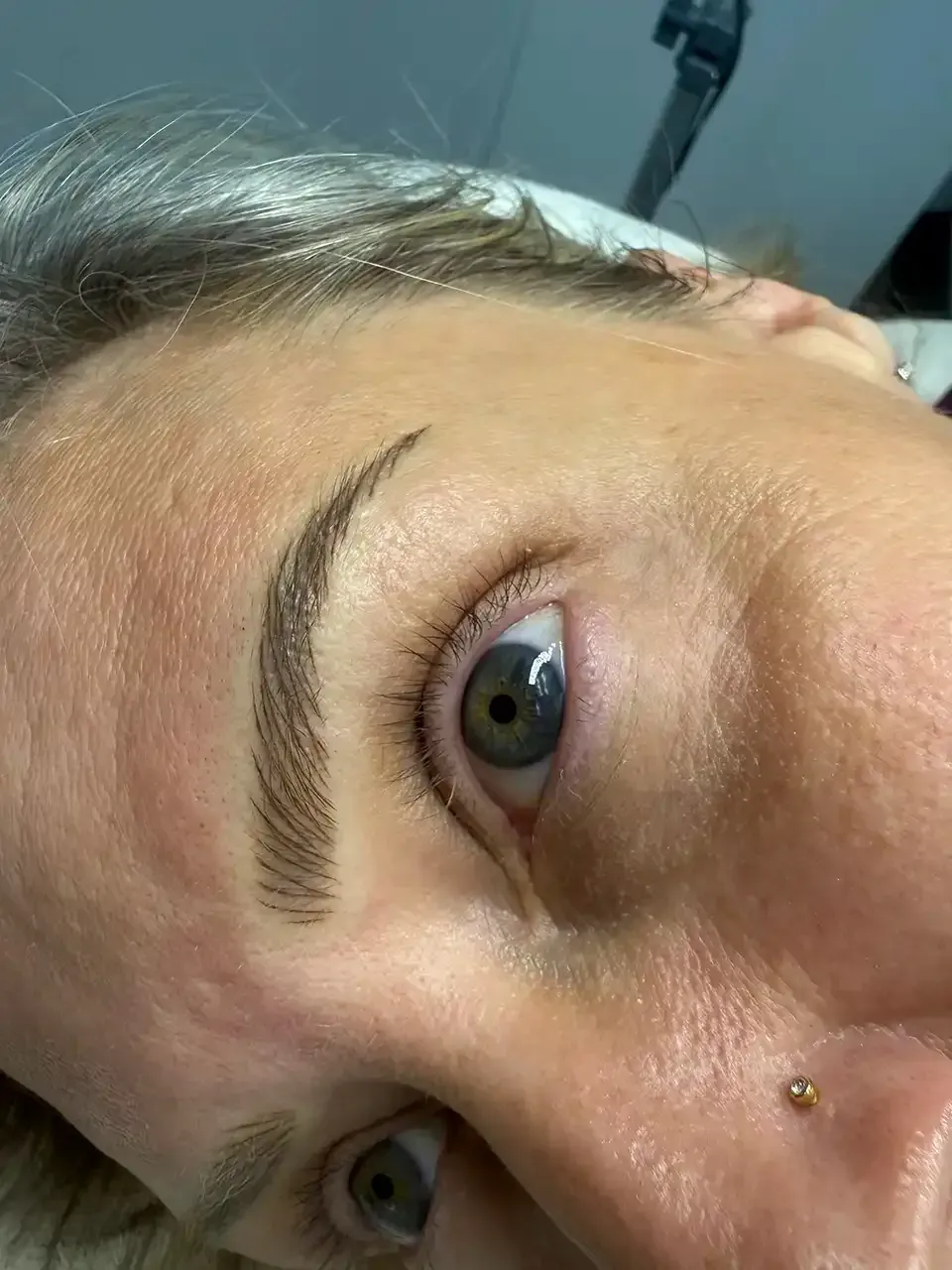 A close up of a woman 's eye and eyebrows.