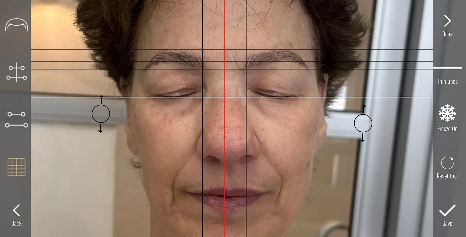 Woman's face with grid overlay, possibly for facial analysis. Closed eyes, neutral expression, natural skin tone.