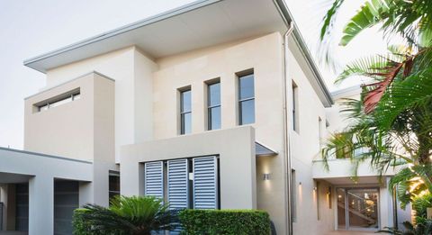 a large white house with a lot of windows and a garage .