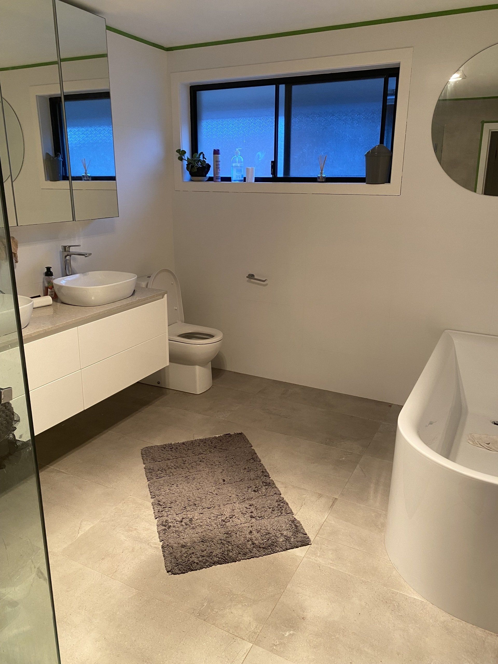 Bathroom With Black Wall Tiles — Plumbing Services in Central Coast, NSW