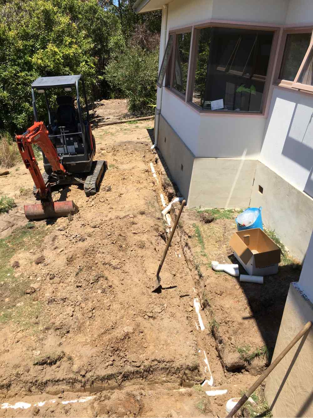 Construction Workers Installing New Pipes — Plumbers in Central Coast, NSW