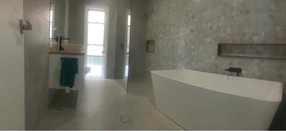 Bathroom With White Bathtub — Plumbers in Central Coast, NSW
