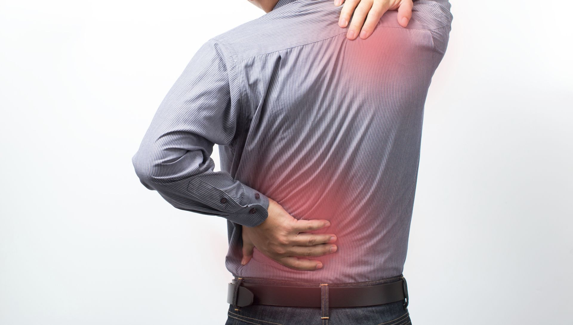 Man with back pain, touching shoulder and lower back, highlighted in red.
