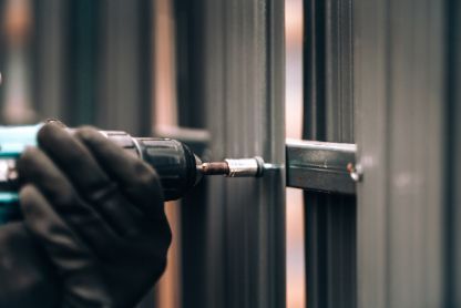 Fence contractor working on repairing a damaged metal fencing in a residential property in Fremantle WA.