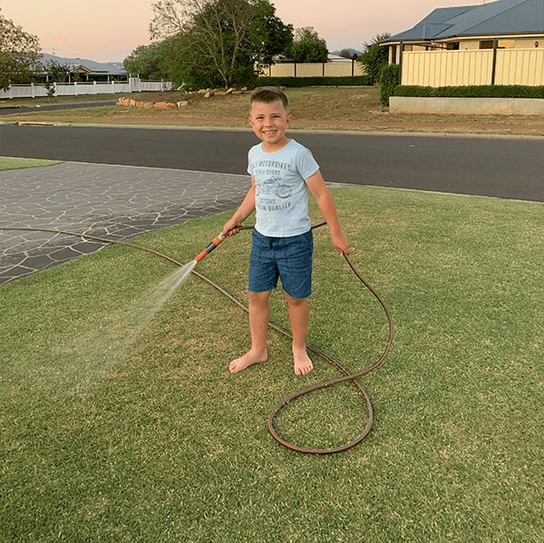 child watering a lawn