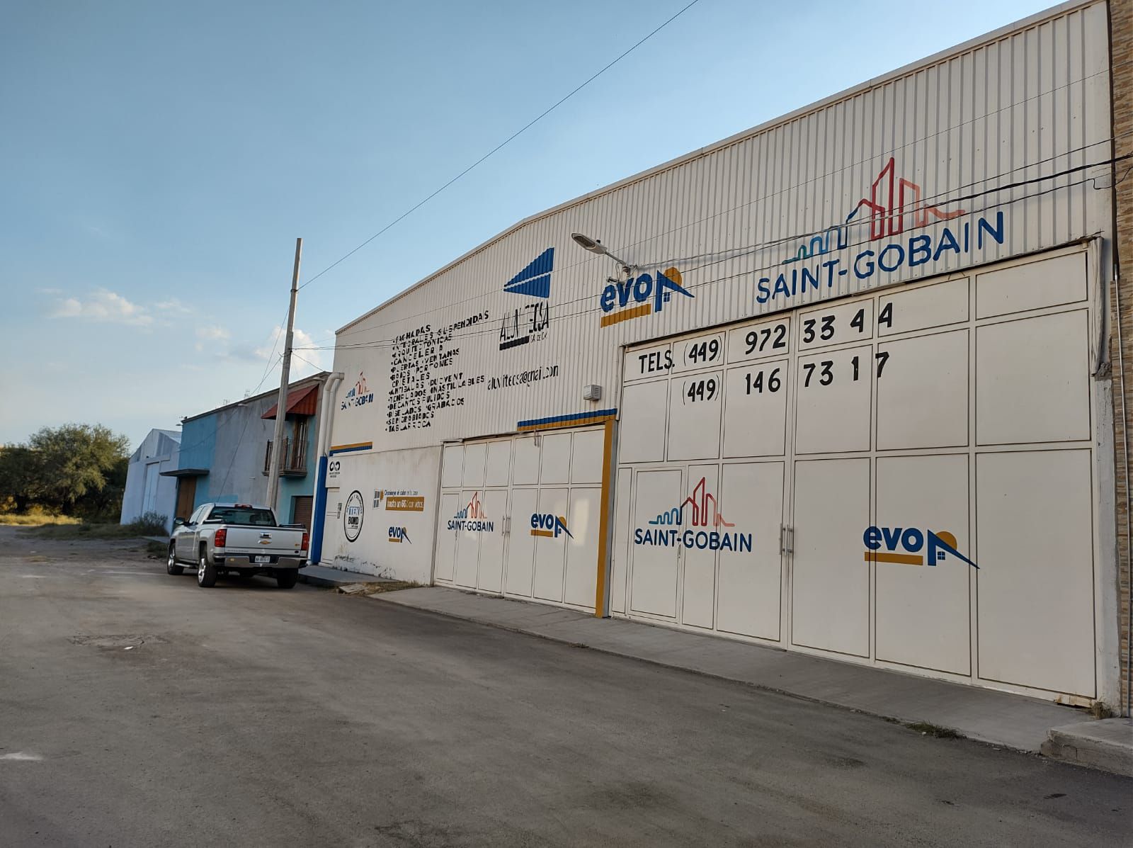 Un camión está estacionado frente a un edificio que dice Saint Gobain.