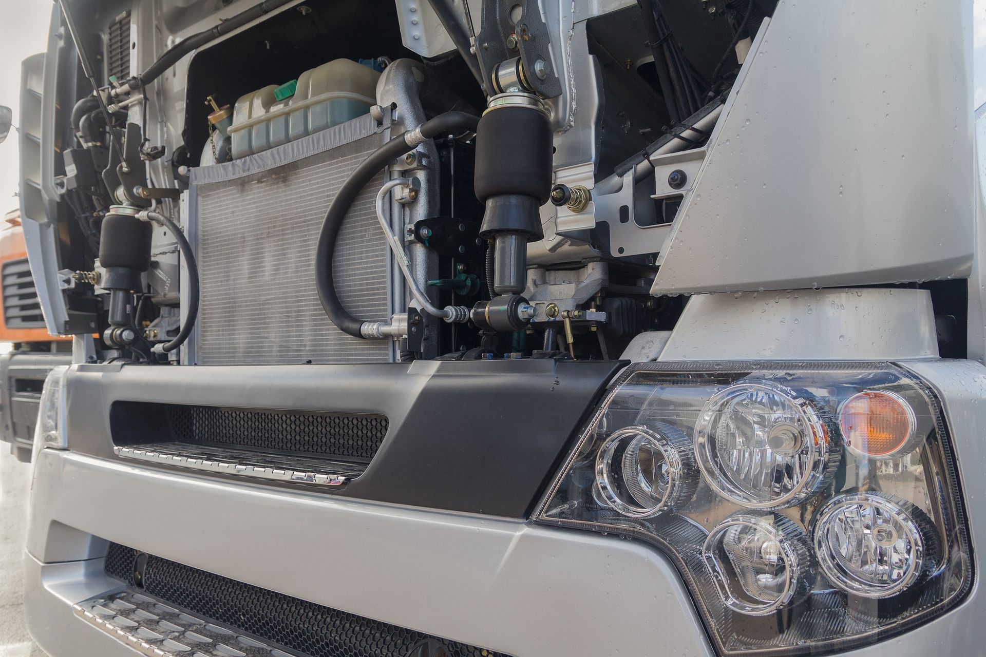 Truck with open motor compartment, showcasing truck radiator repair for commercial fleets.