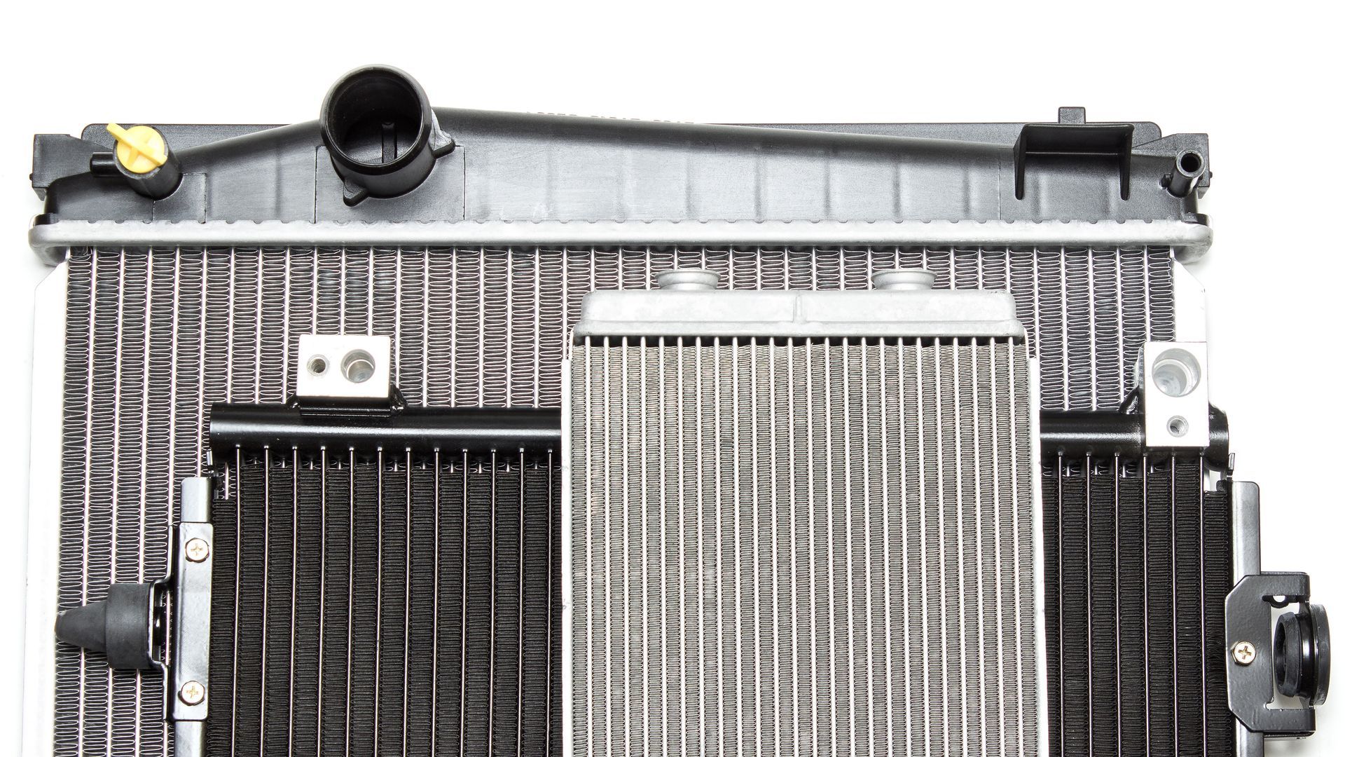 Close-up of an automotive radiator assembly showing cooling fins and metal components.