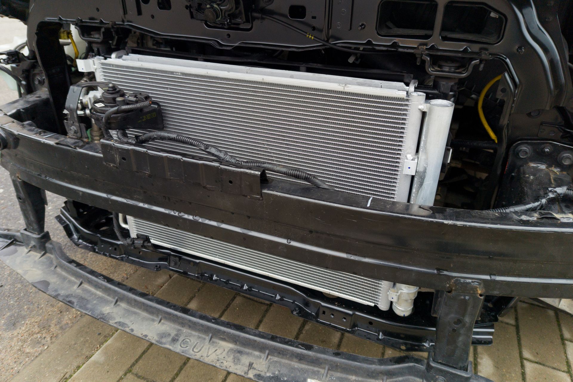 The front bumper of a car with the radiator removed.