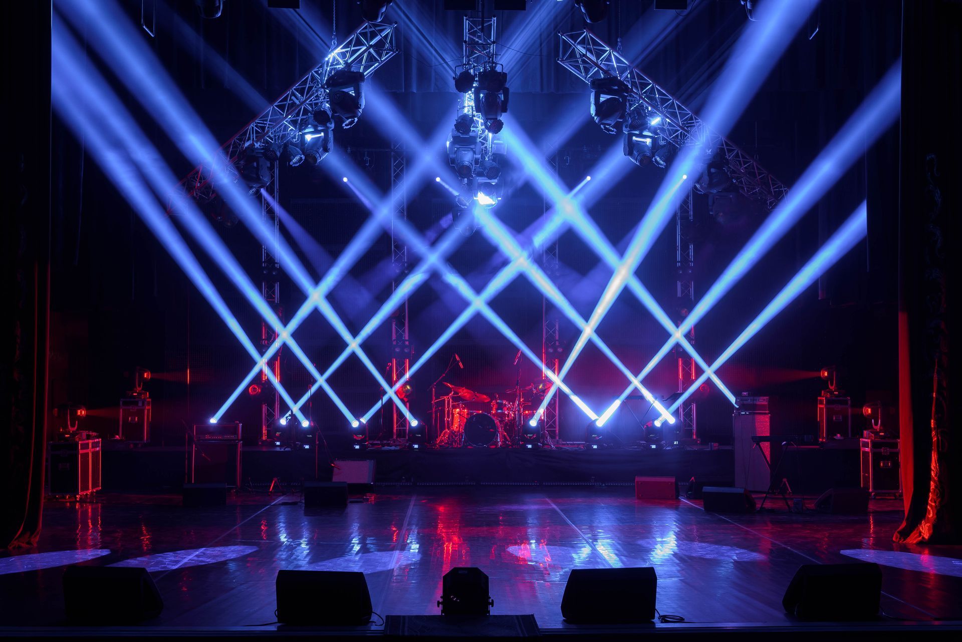 A dark stage with blue lights, showcasing event lighting.