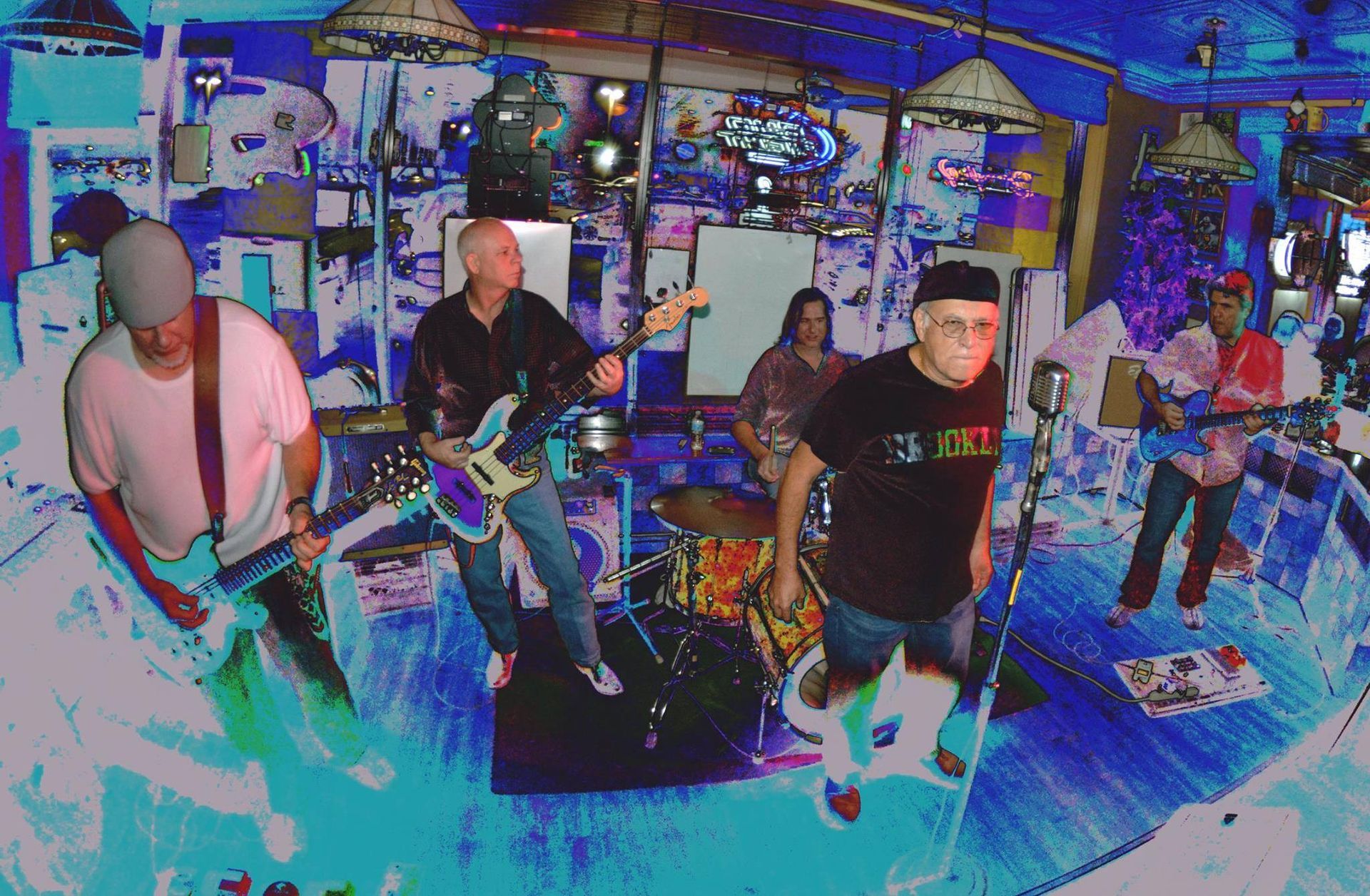 A band performing on a stage, brightly colored and stylized. Five musicians play instruments, including guitars and drums.