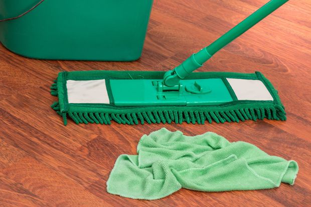 Mop on clean floor with cleaning microfiber rag