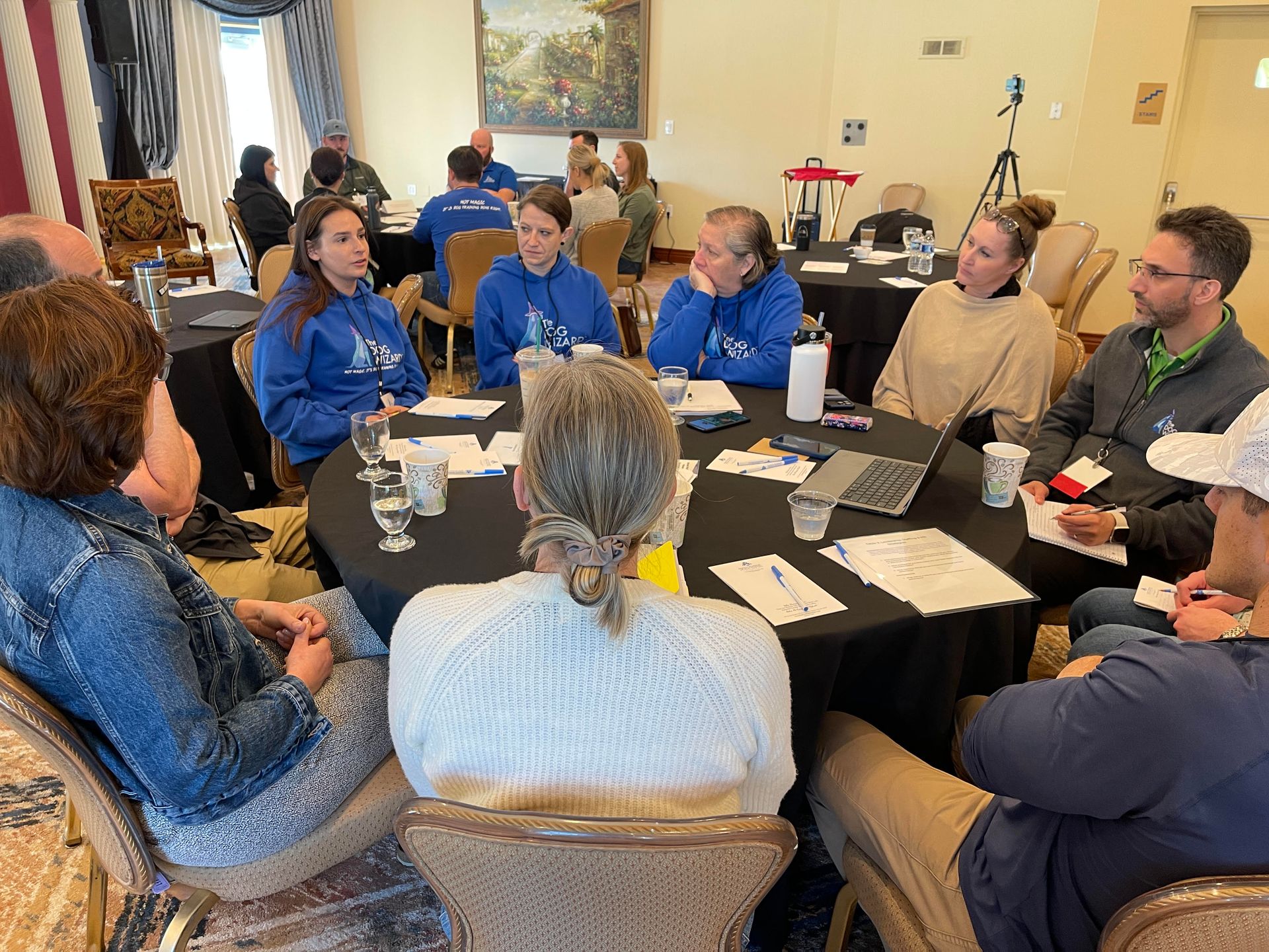 A group of people are sitting around a table in a room.