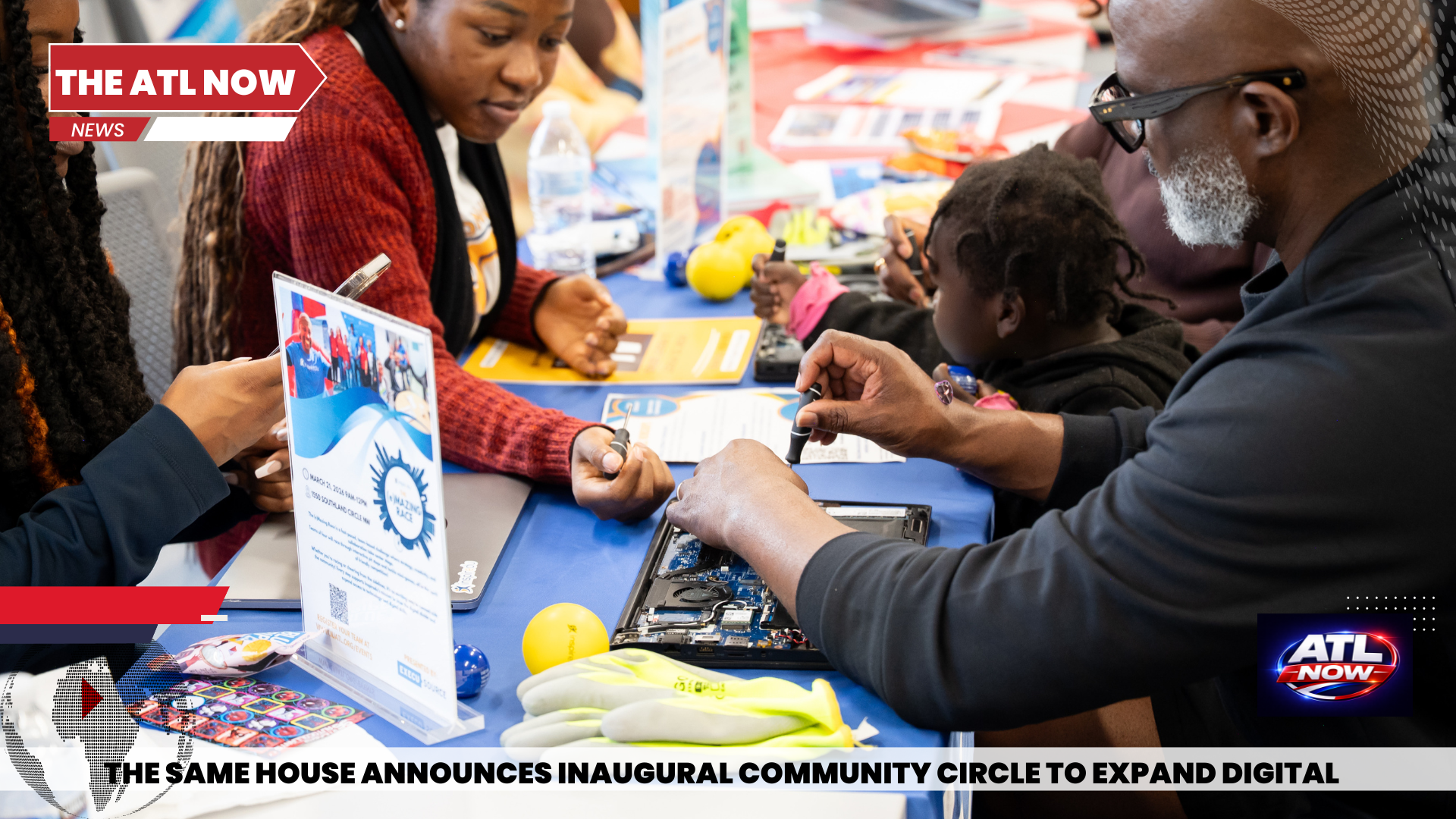 Community expo table with people exchanging items and reading flyers at a digital skills event