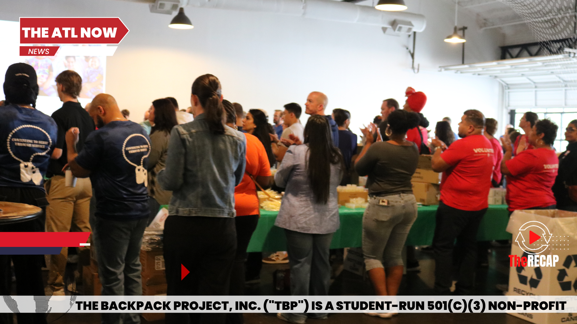 People gathered in a bright indoor hall for a community fitness event.