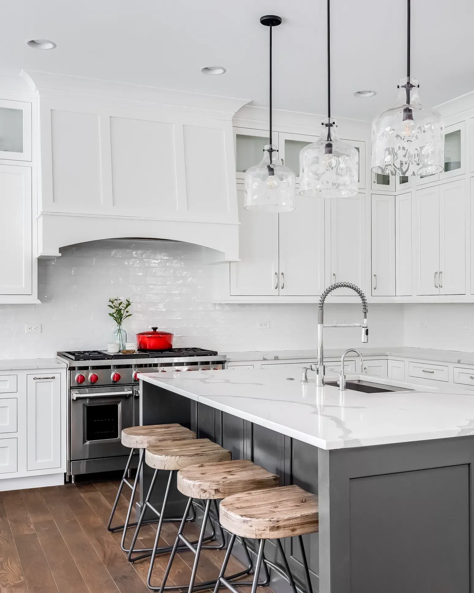 A kitchen with white cabinets , a stove , a sink , and a large island in Southeast Portland