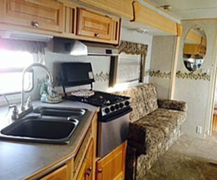 A kitchen with a sink stove and a couch