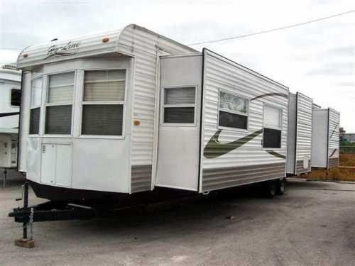 A white trailer is parked in a parking lot.