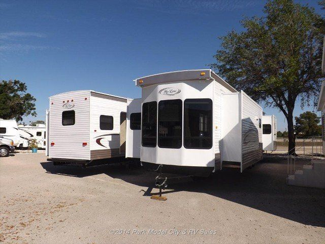 A white rv is parked next to another white rv