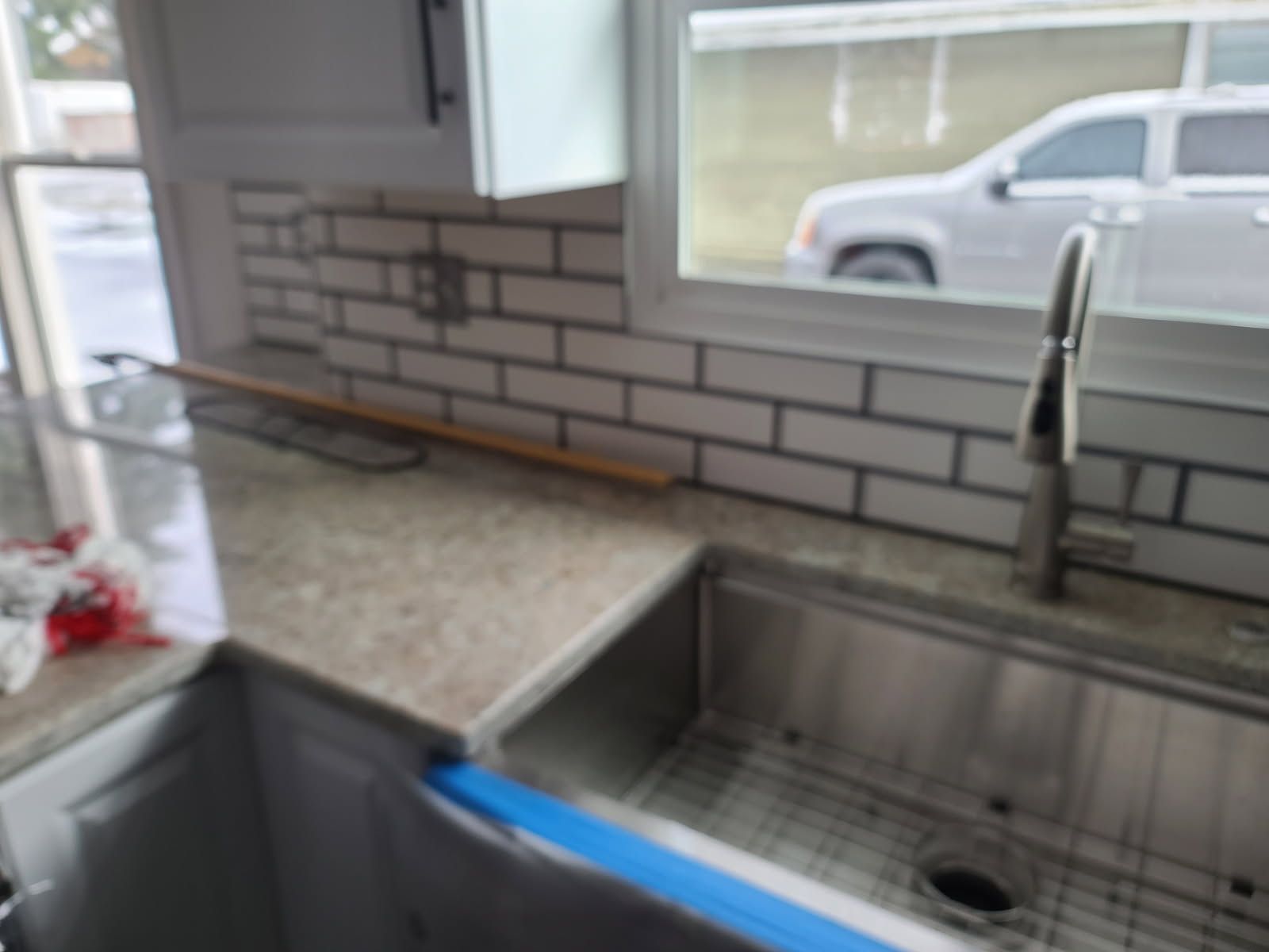 Wooden deck with outdoor furniture, potted flowers, and a yellow-leaved tree.